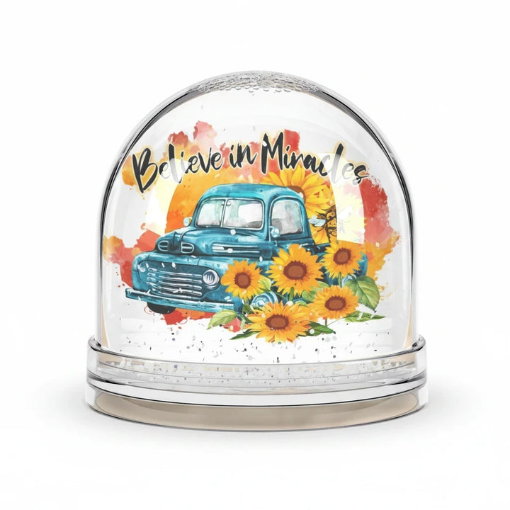Sea Dragon Dreams snow globe featuring a vintage blue truck, sunflowers, and the text Believe in Miracles.