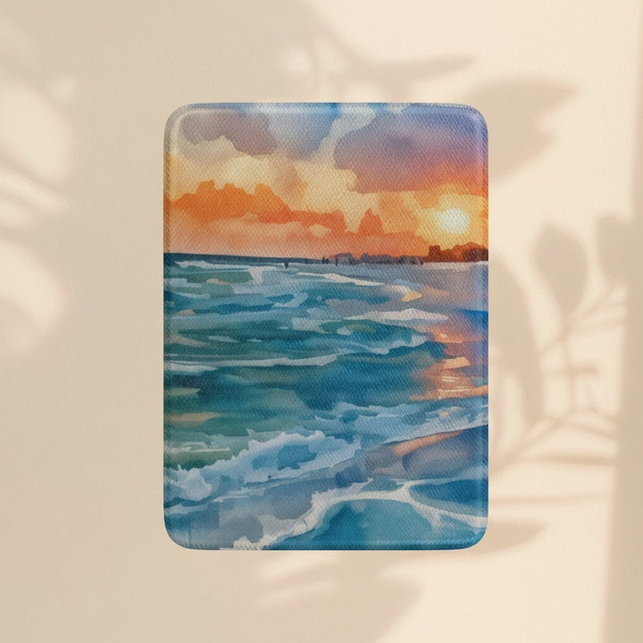 Sea Dragon Dreams Kindle case featuring a vibrant watercolor sunset over a blue ocean with a smooth satin finish