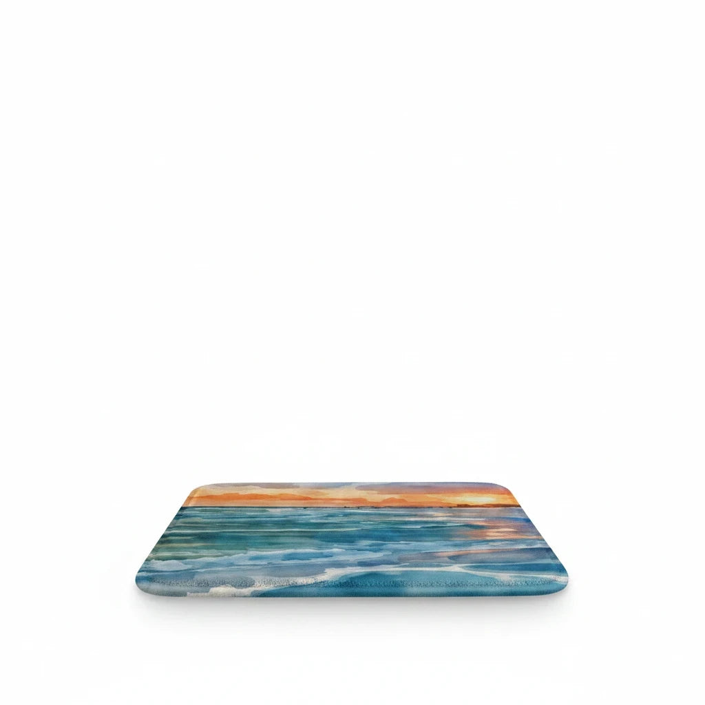 Sea Dragon Dreams Kindle case featuring a vibrant watercolor sunset over a calm ocean with soft coastal hues.