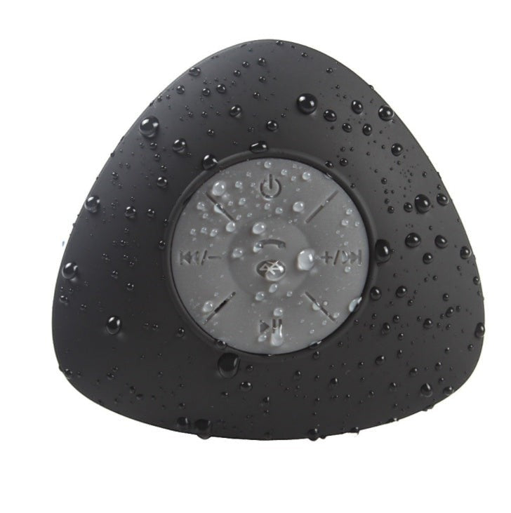 Sea Dragon Dreams waterproof black triangular Bluetooth shower speaker with water droplets on the surface