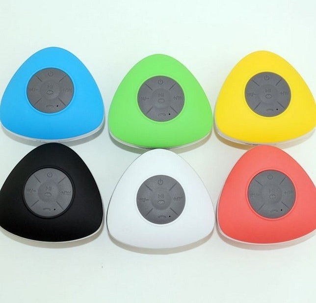 Sea Dragon Dreams waterproof triangular Bluetooth shower speakers in blue, green, yellow, black, white, and red.