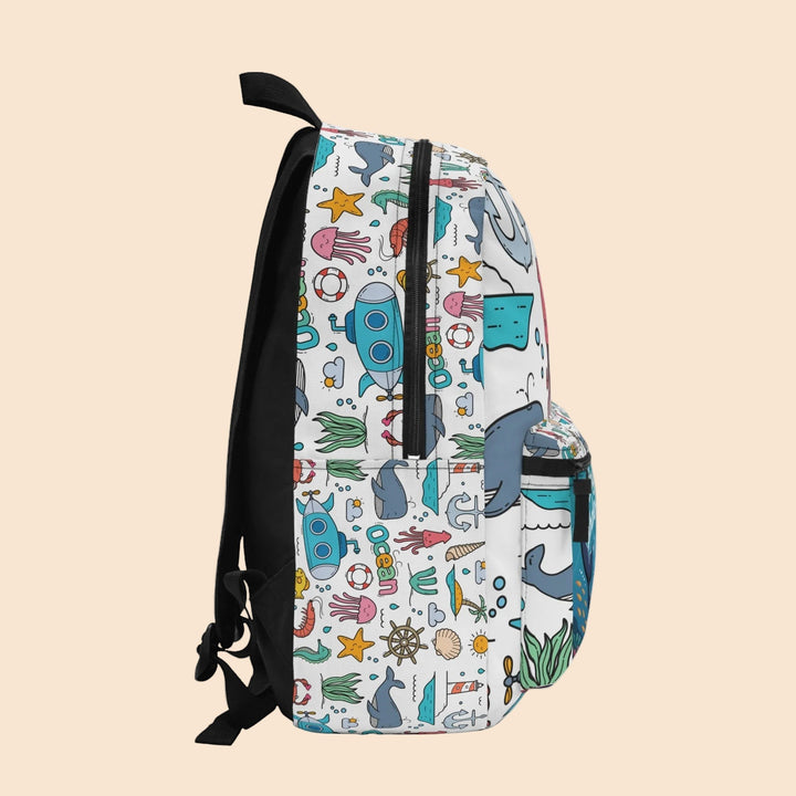 Sea Dragon Dreams whale backpack with whimsical ocean motifs like submarines, starfish, and jellyfish on white fabric