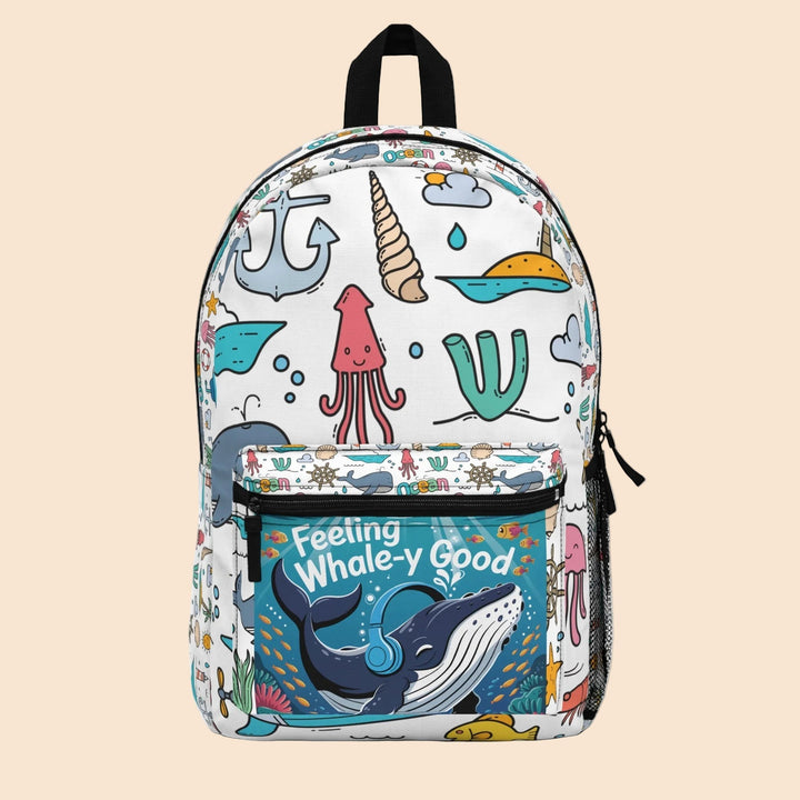 Sea Dragon Dreams polyester backpack featuring a whimsical whale print with ocean motifs and Feeling Whale-y Good text.