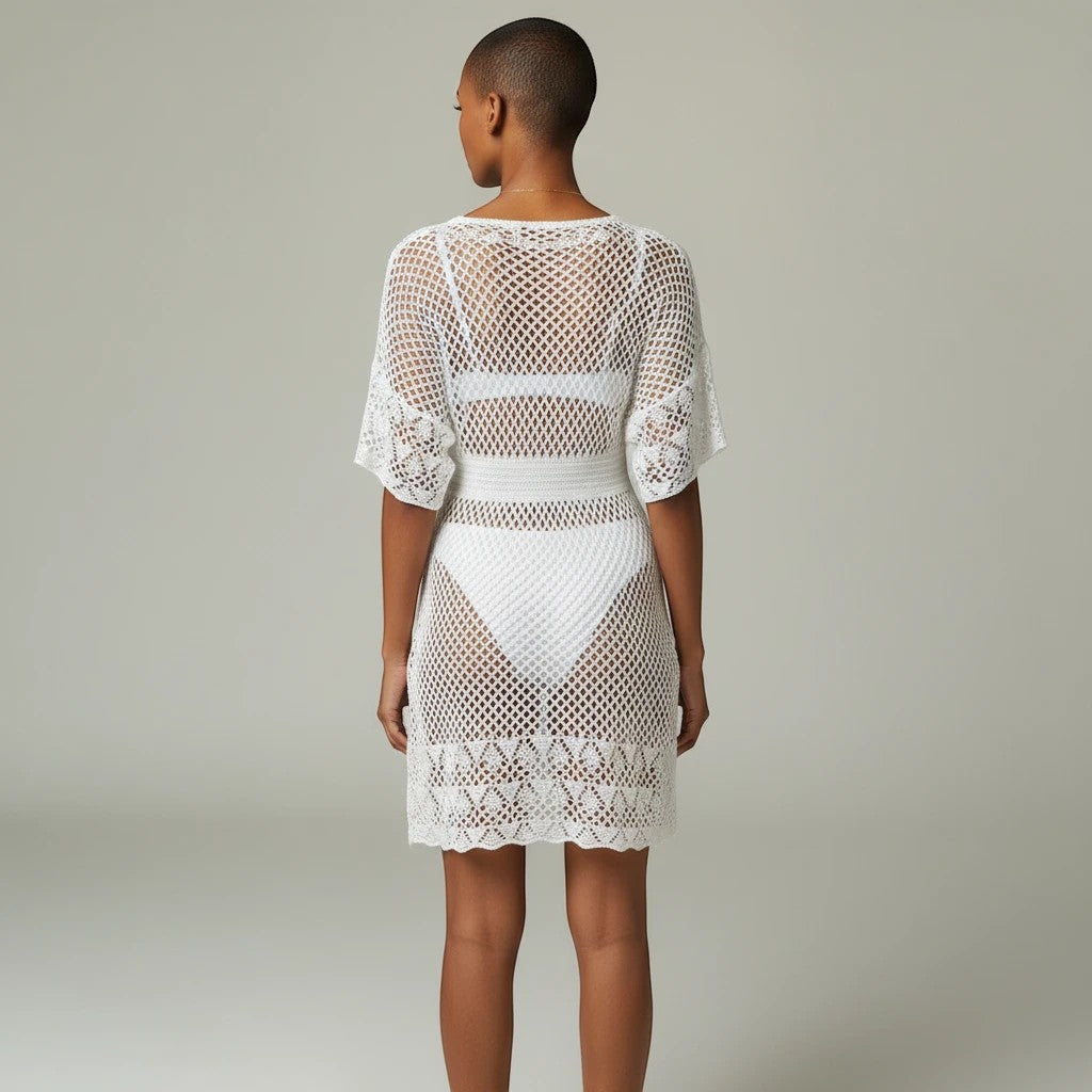 Sea Dragon Dreams white openwork crochet beach cover-up dress with spaghetti straps, back view on a model.