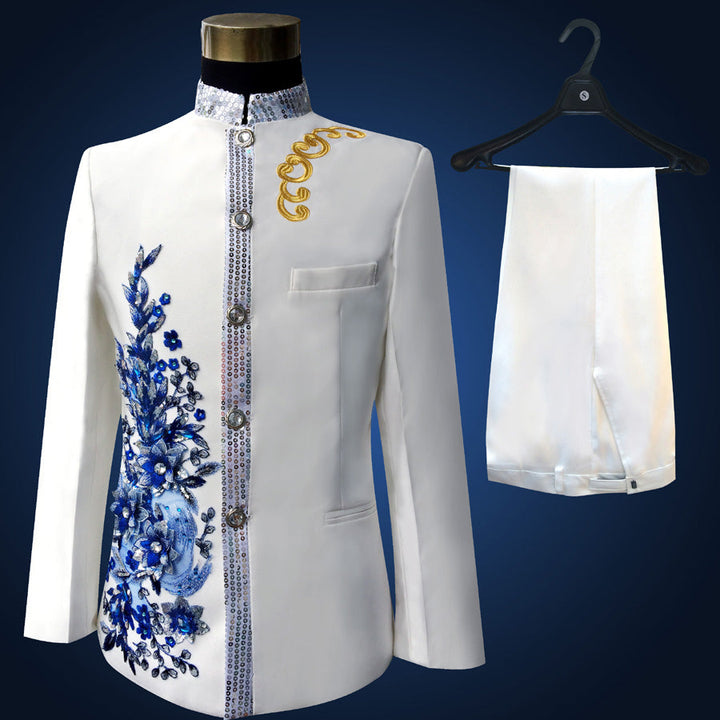Sea Dragon Dreams white slim-fit tuxedo suit with blue floral embroidery, paillette accents, and matching trousers.