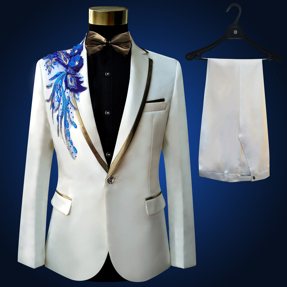 Sea Dragon Dreams white slim-fit tuxedo blazer with blue floral embroidery, gold trim, and matching dress trousers.