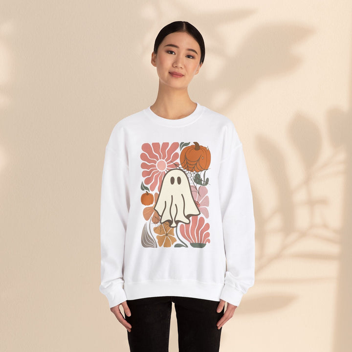 Sea Dragon Dreams white crewneck sweatshirt featuring a retro ghost and pumpkin graphic on a woman.