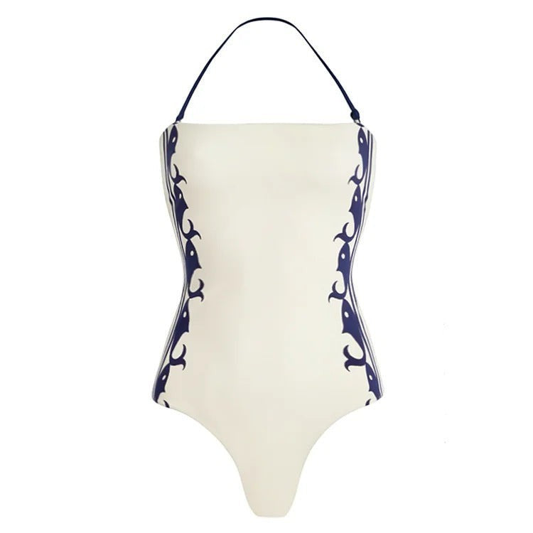 Sea Dragon Dreams white one-piece swimsuit with navy blue halter straps and decorative side patterns