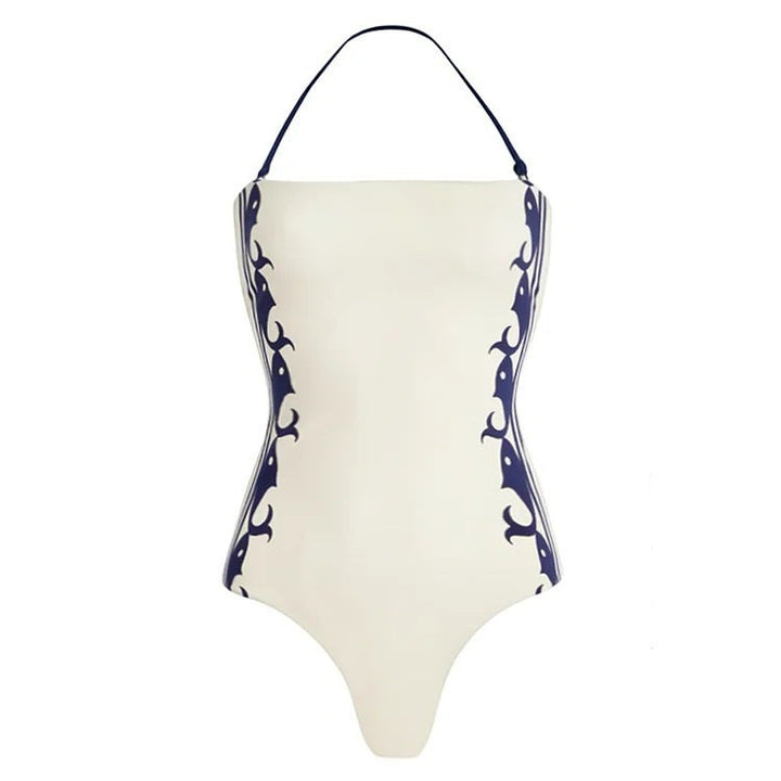 Sea Dragon Dreams white one-piece swimsuit with navy blue halter straps and decorative side patterns