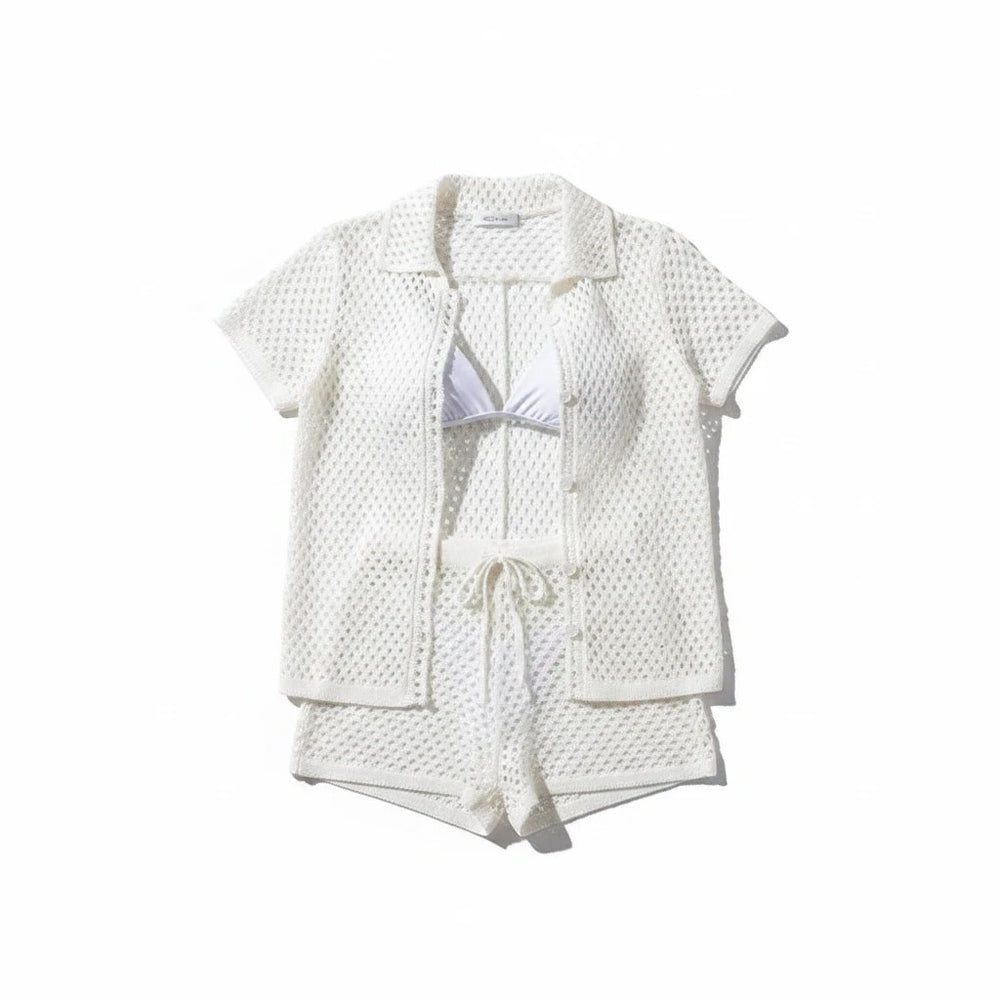 Sea Dragon Dreams white hollow-out knit two-piece beach cover-up set with short-sleeve cardigan and drawstring shorts.