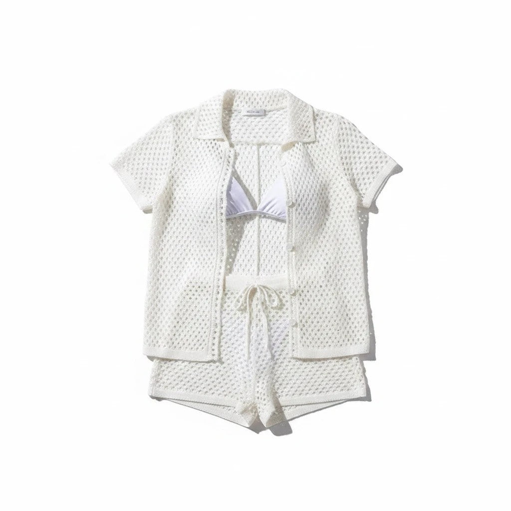 Sea Dragon Dreams white hollow-out knit two-piece beach cover-up set with short-sleeve cardigan and drawstring shorts.
