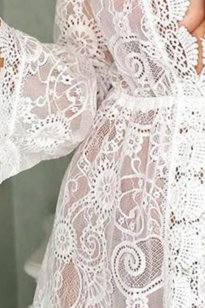 Sea Dragon Dreams white lace V-neck cover-up dress featuring intricate floral patterns and sheer long sleeves.