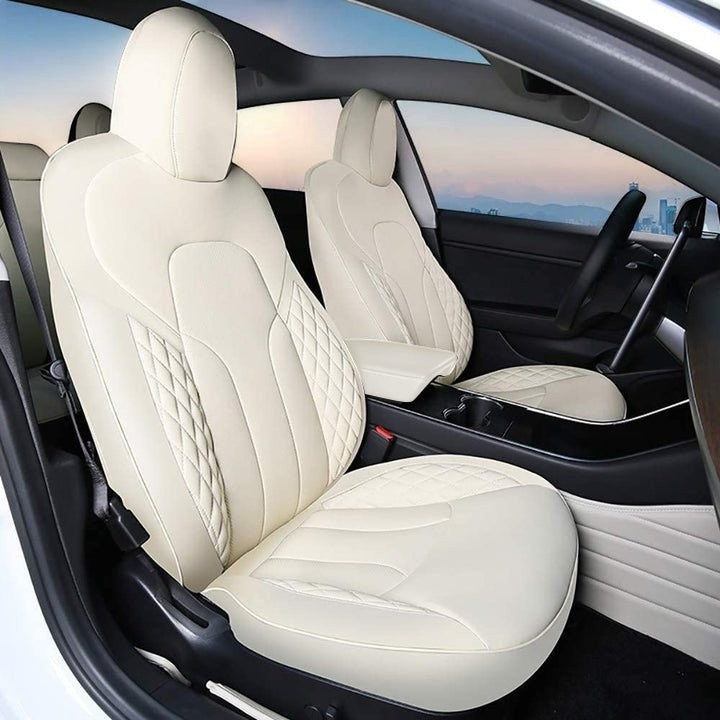 Sea Dragon Dreams white leather seat covers installed in a Tesla Model 3 or Model Y with diamond-stitched detailing.