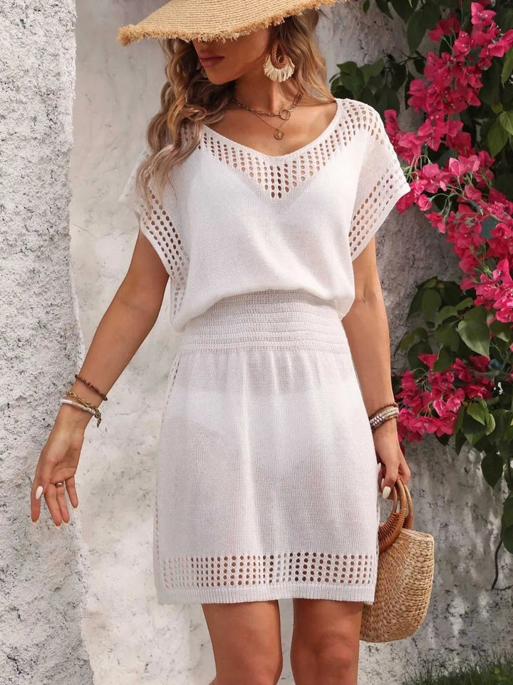 Sea Dragon Dreams white openwork V-neck cover-up dress with short sleeves and a cinched waist on a woman.