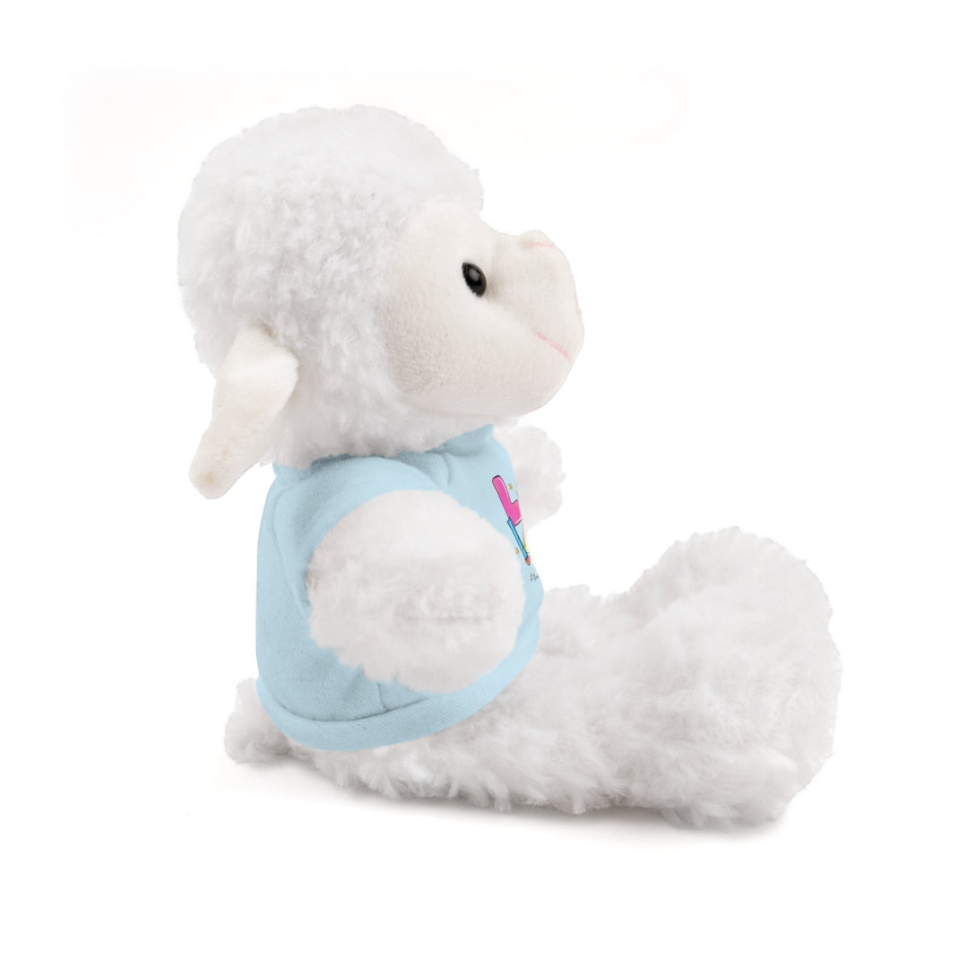 Sea Dragon Dreams white plush sheep stuffed animal wearing a light blue cotton t-shirt, side view.