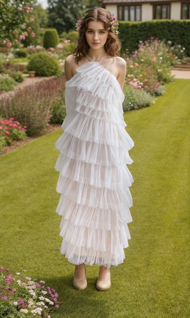 Sea Dragon Dreams white tulle prom dress with layered ruffles and halter neckline worn by a model in a garden.