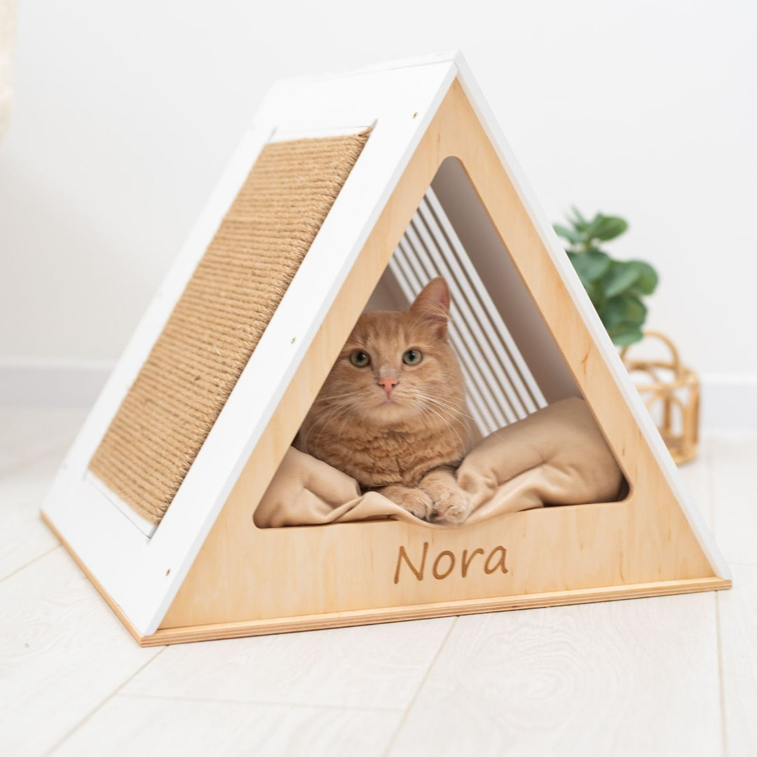 Sea Dragon Dreams modern white wooden A-frame cat house with a sisal scratching side and a cozy interior cushion.