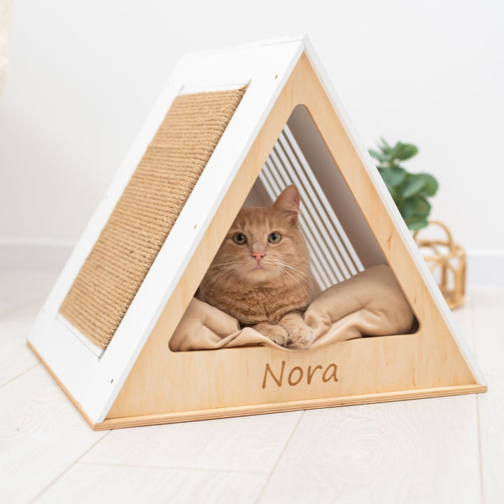 Sea Dragon Dreams modern white wooden A-frame cat house with a sisal scratching side and a cozy interior cushion.