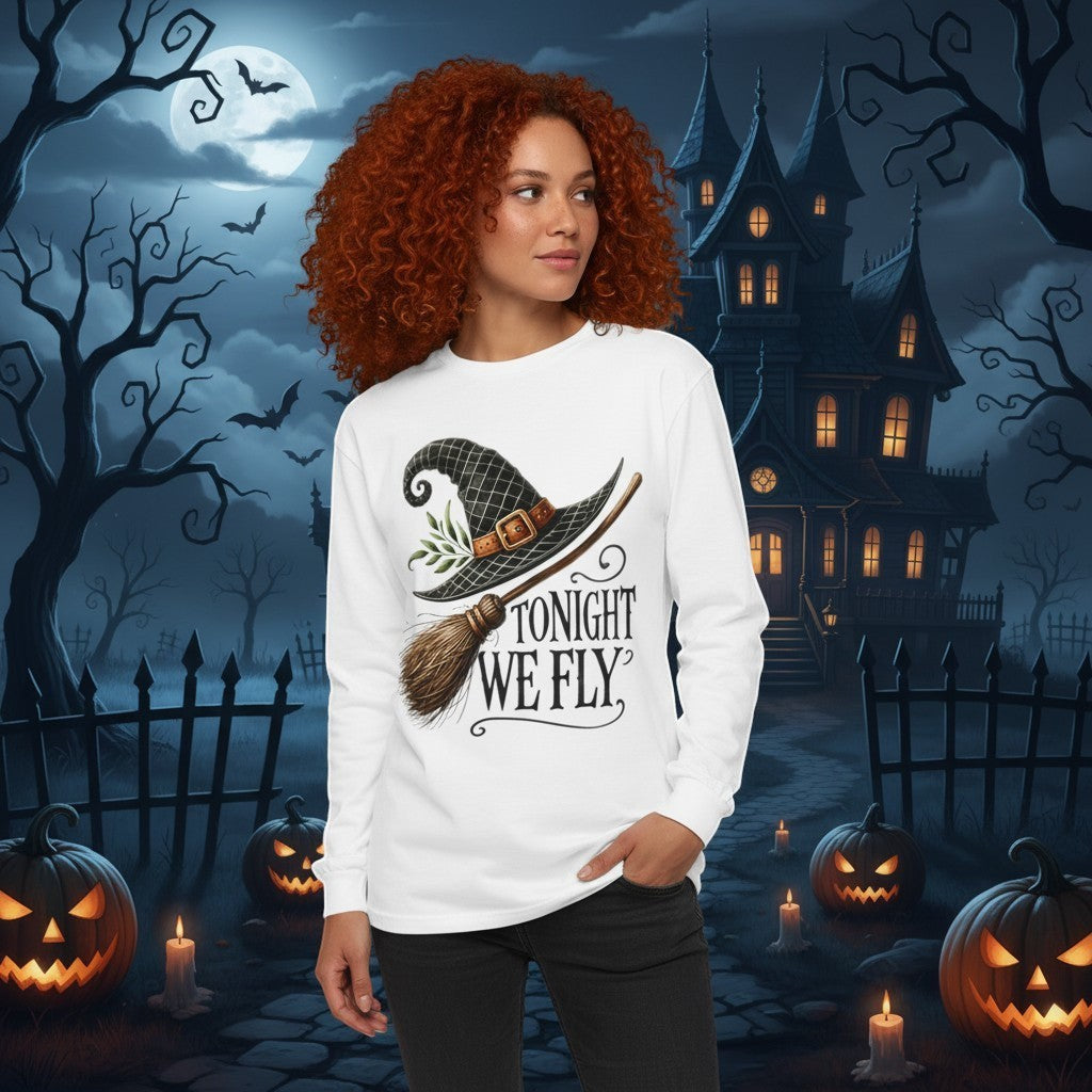 Sea Dragon Dreams white long sleeve t-shirt with Tonight We Fly witch hat graphic worn by a woman in a spooky setting