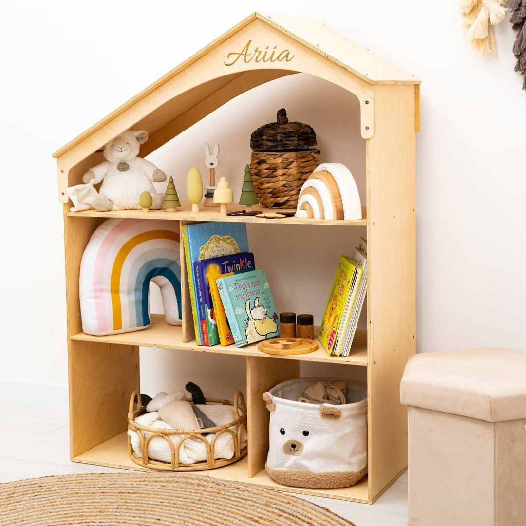 Sea Dragon Dreams wooden dollhouse bookcase with personalized name engraving on the roof, filled with toys and books.