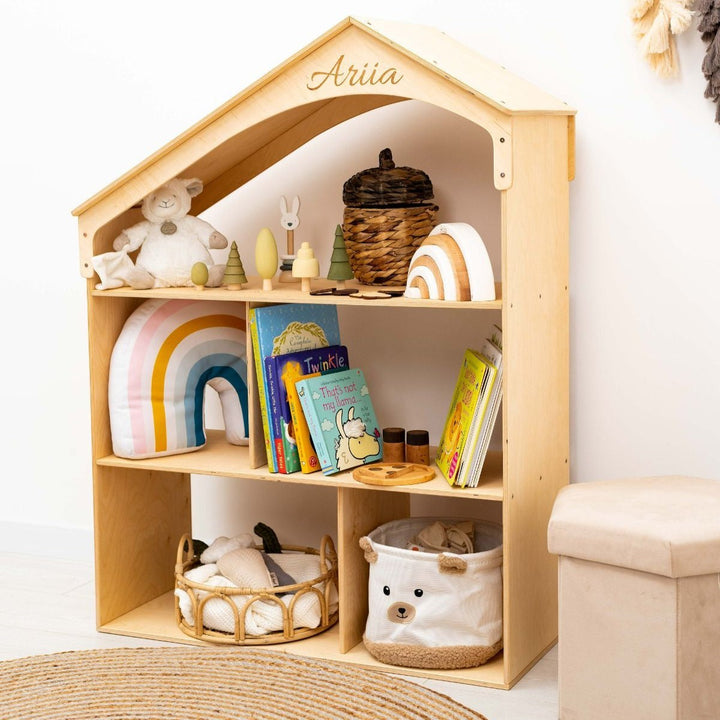 Sea Dragon Dreams wooden dollhouse bookcase with personalized name engraving on the roof, filled with toys and books.