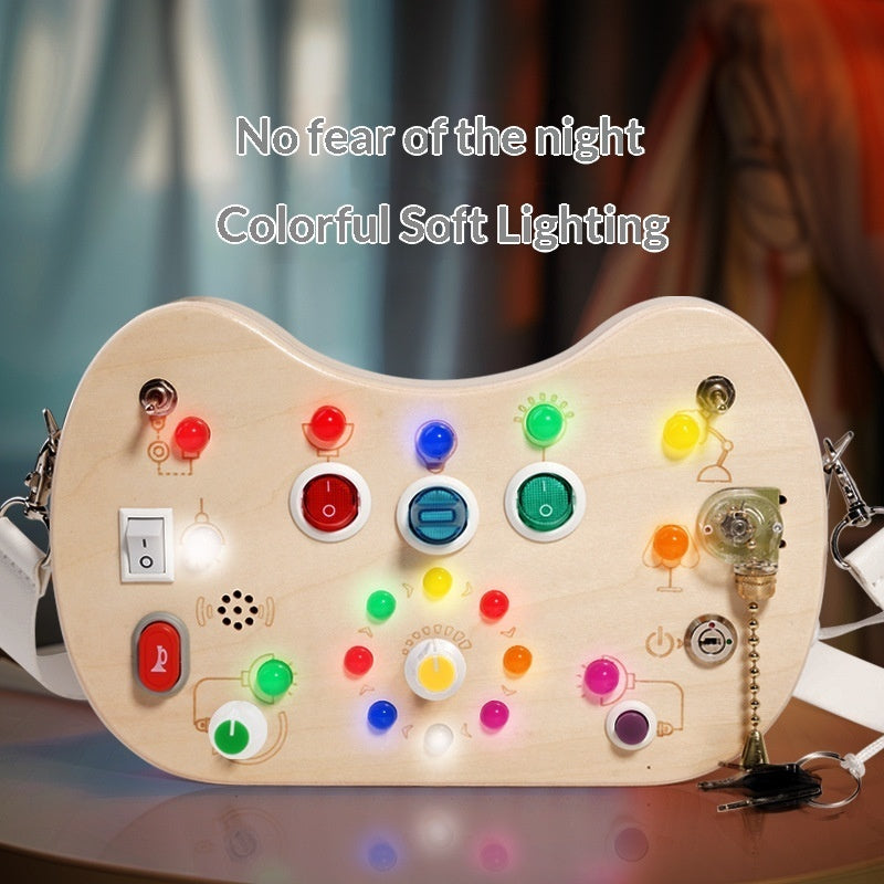 Sea Dragon Dreams wooden busy board with colorful LED lights, interactive switches, and buttons for sensory play