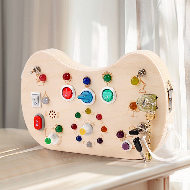 Sea Dragon Dreams wooden busy board with colorful LED lights, switches, and buttons for sensory and motor skill play.