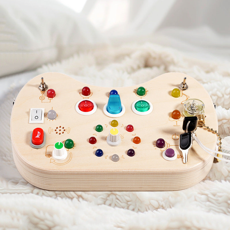 Sea Dragon Dreams wooden busy board with colorful LED lights, switches, and buttons for toddler sensory development