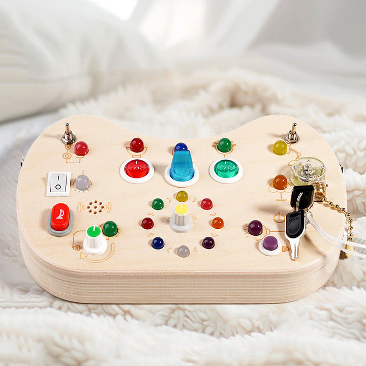 Sea Dragon Dreams wooden busy board with colorful LED lights, switches, and buttons for toddler sensory development