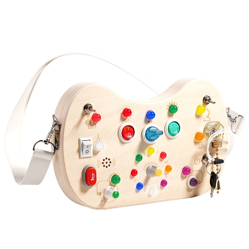 Sea Dragon Dreams wooden busy board with colorful LED lights, interactive switches, and buttons for sensory play.