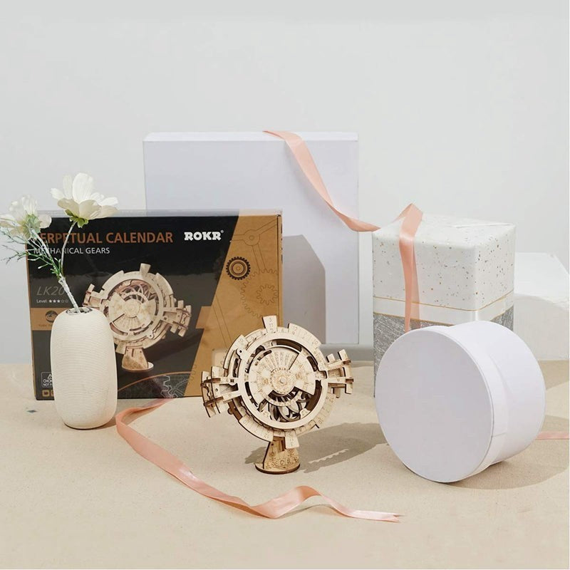 Sea Dragon Dreams wooden mechanical gear perpetual calendar puzzle kit displayed with gift boxes and a small vase