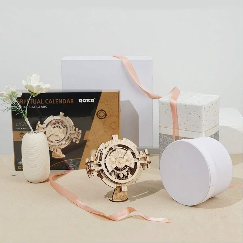 Sea Dragon Dreams wooden mechanical gear perpetual calendar puzzle kit displayed with gift boxes and a small vase