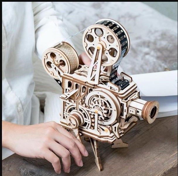 Sea Dragon Dreams wooden mechanical film projector 3D puzzle being operated by hand crank