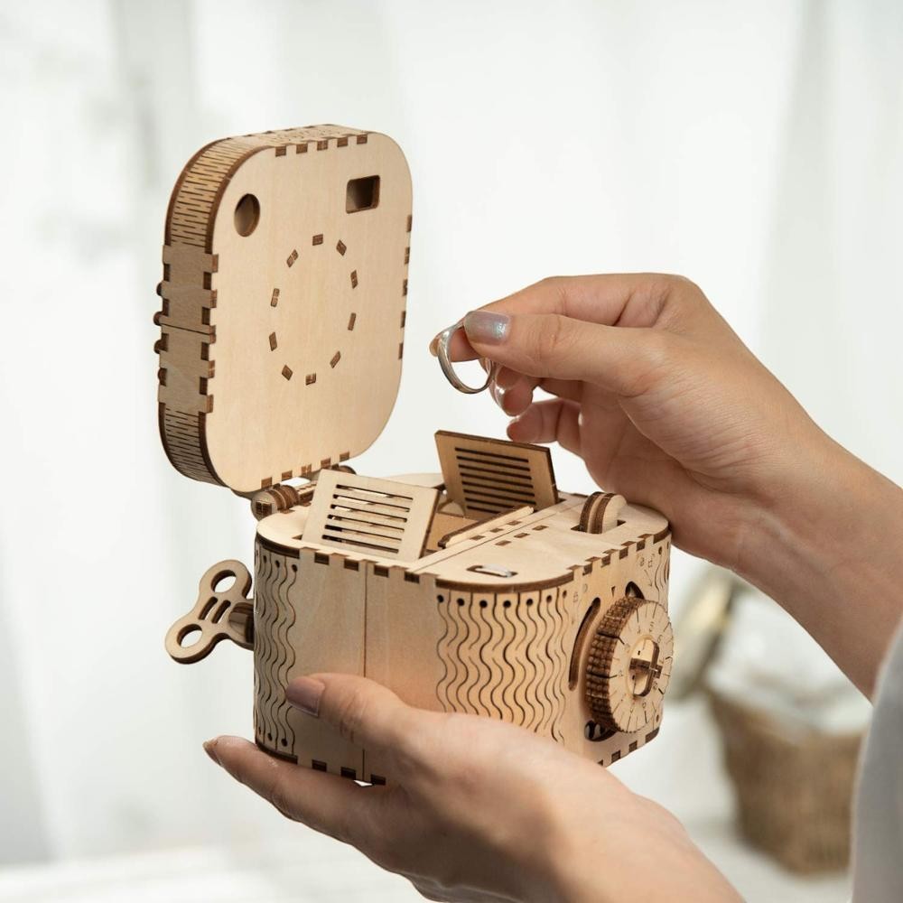 Sea Dragon Dreams wooden mechanical film projector puzzle being assembled by hand with a ring inside