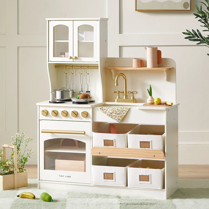 Sea Dragon Dreams Tiny Land wooden play kitchen in cream and sage with storage bins, faucet, and pretend cookware.