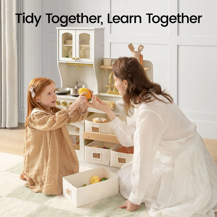Sea Dragon Dreams wooden play kitchen in cream and sage with a mother and daughter playing with toy food