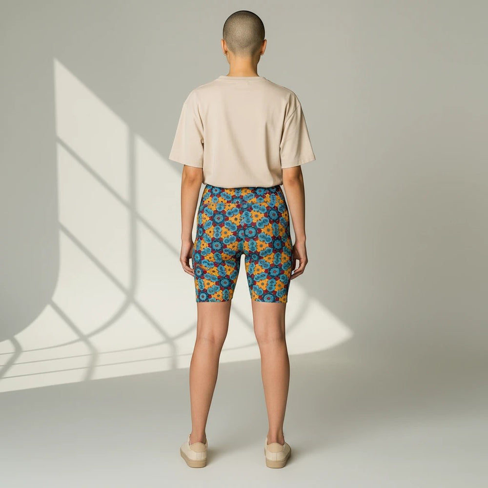 Sea Dragon Dreams women's workout shorts with a colorful street dragon pattern, worn with a beige t-shirt, back view.