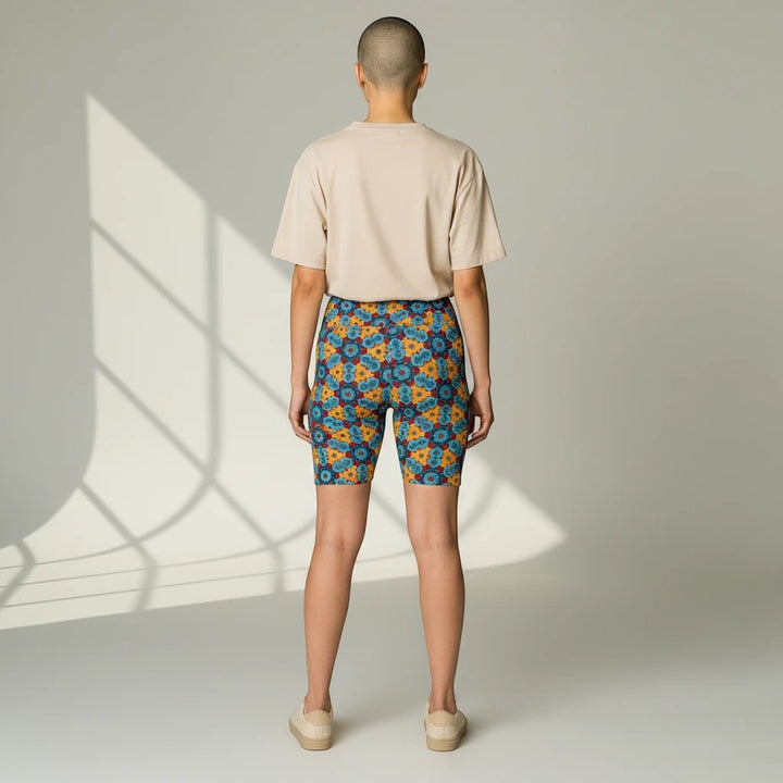 Sea Dragon Dreams women's workout shorts with a colorful street dragon pattern, worn with a beige t-shirt, back view.