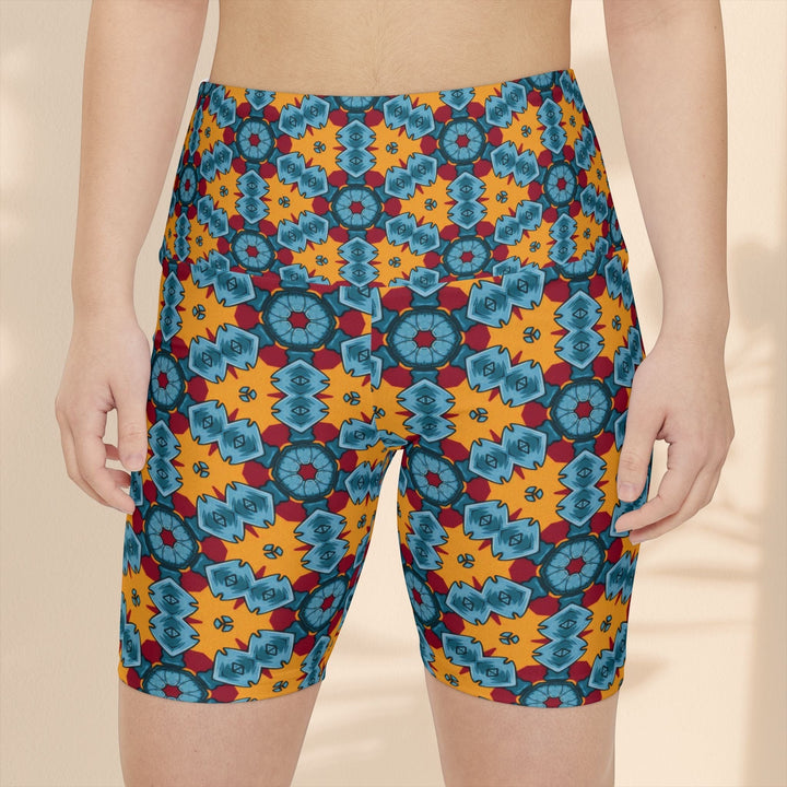 Sea Dragon Dreams women's workout shorts featuring a vibrant orange, blue, and red dragon-inspired geometric pattern.