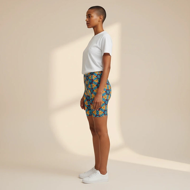 Model wearing Sea Dragon Dreams workout shorts with a colorful street dragon pattern and a white t-shirt, side view.