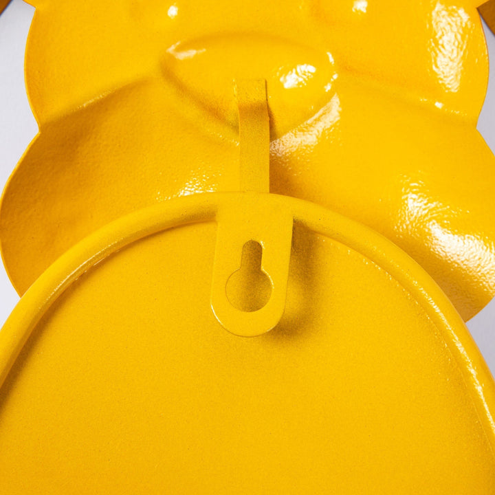 Sea Dragon Dreams yellow metal dog toilet paper holder showing the rear mounting bracket for wall display