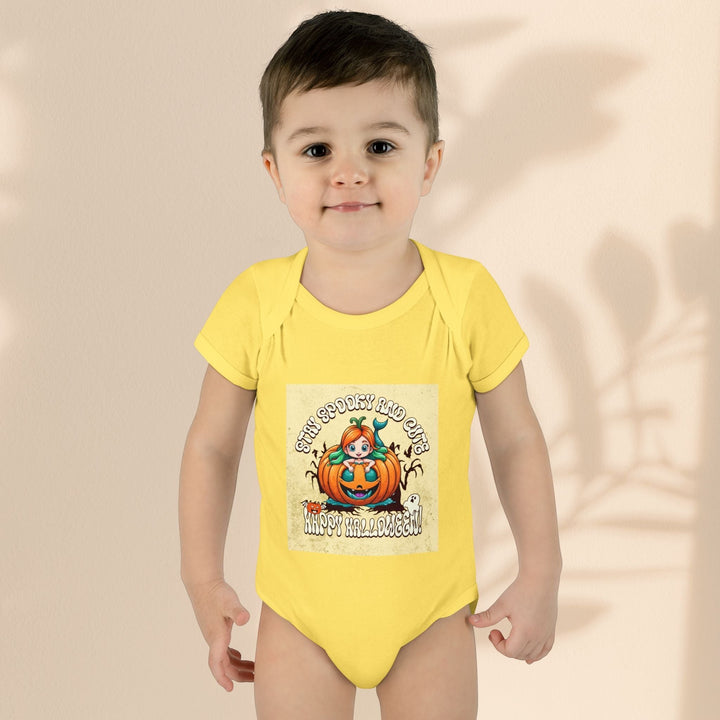Sea Dragon Dreams infant bodysuit in yellow cotton with a Stay Spooky and Cute pumpkin Halloween graphic print