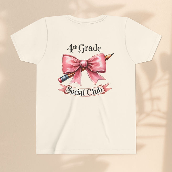 Sea Dragon Dreams youth cream t-shirt featuring a 4th Grade Social Club graphic with a pink bow and pencil design.